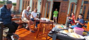 a group of people sitting around a table at Kopa HillTop - Family Guest Home in Ruteng