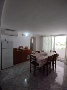 a kitchen and dining room with a table and chairs at Casa Nannina in Ischia Town