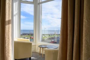 a room with a large window with a view of the ocean at The Sandbeck, Glaisdale in Whitby