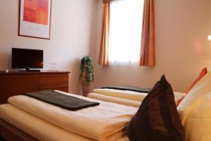 Un pat sau paturi într-o cameră la Hotel Checkin