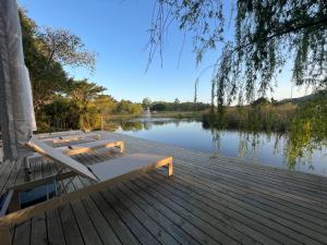a wooden dock with benches and a lake at Kwendalo in Plettenberg Bay +6 photos
