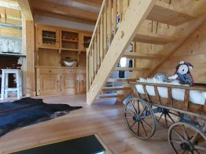 a staircase in a log cabin with teddy bears in a wagon at Chalet Dalpe by Quokka 360 - chalet among pastures and forests in Dalpe