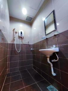 a bathroom with a sink and a shower at TREX_Batu Pahat Homestay in Batu Pahat