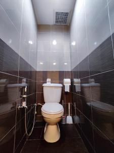 a bathroom with a toilet and a shower at TREX_Batu Pahat Homestay in Batu Pahat