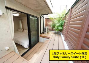 a small room with a bed and a balcony at Laffitte Tokyo WEST in Tokyo