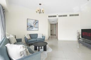 a living room with a couch and a table at VayK - Delightful 2BR in JLT with Marina Views in Dubai