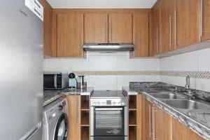a kitchen with a sink and a dishwasher at VayK - Delightful 2BR in JLT with Marina Views in Dubai
