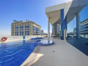 a swimming pool on the roof of a building at VayK - Delightful 2BR in JLT with Marina Views in Dubai