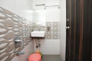 a bathroom with a sink and a toilet in it at Hotel Mahi in Mumbai
