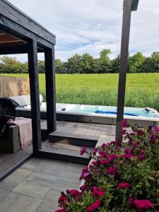 a hot tub in a garden with flowers at B&B Veluwemeer in Biddinghuizen