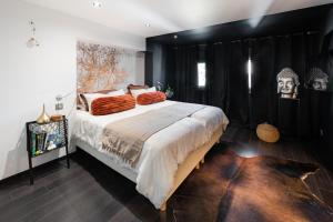 a bedroom with a large bed with black walls at ALSACE Cosy in Schoenau
