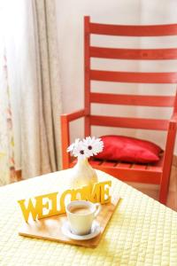 a welcome sign and a cup of coffee on a table at Beach House Haller in Aljezur