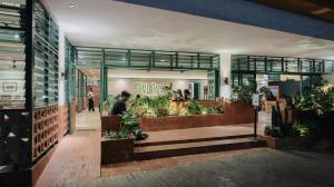 a store front of a store with plants in it at The Win Hotel Surabaya in Surabaya