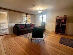 a living room with a couch and a table at Ferienwohnungen Weingut Pieper Basler in Offenburg