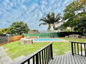 a backyard with a swimming pool and a fence at Entire House in Beacon Bay - Family or Group Retreat - Swimming Pool - Multiple Braais in East London