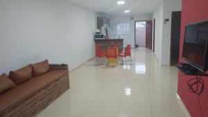 a living room with a couch and a table at Casa de praia com picina 2 in São José da Coroa Grande