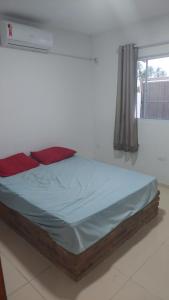 a bed sitting in a room with a window at Casa de praia com picina 2 in São José da Coroa Grande +7 photos