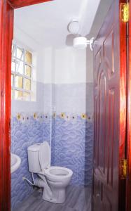 a bathroom with a toilet and a sink at RUPITAL SUITE's in Nakuru