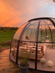 a gazebo with a table and a bench in it at Au Clair de ma Bulle in Marche-en-Famenne +21 photos