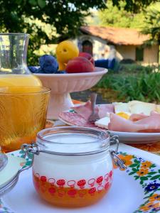 a table with a jar of honey and a plate of food at Casa Stella Country House in Savigno