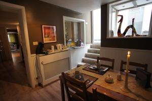 a dining room with a table with a candle on it at B&B Wellness Yoake in Ypres