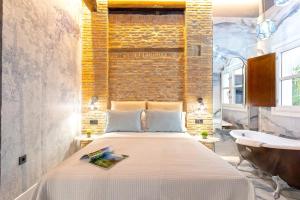 a bedroom with a large bed and a sink at Genteel Home Catedral Granada in Granada