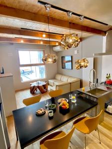 a kitchen and living room with a black table and chairs at Abuta-gun - House - Vacation STAY 14526 in Kutchan