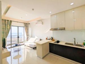 a kitchen with a sink and a couch in a room at Lovina 21-07 at Harbour Bay Residence(Near Ferry) in Batu Ampar