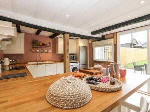 a kitchen with a large wooden table in a room at Lavender Cottage in Malvern Link