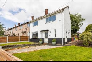 an exterior view of a white house at Entire Immaculate 3 Bedrooms House in Blackburn Weekend Away in Blackburn