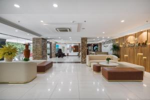 a lobby with couches and tables in a building at Star Hotel and Spa Danang in Danang
