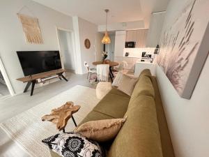 uma sala de estar com um sofá e uma televisão em 2 Room / Central Railway / Free parking / Sauna em Oulu