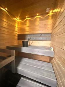 a sauna with a bench in a wooden wall at 2 Room / Central Railway / Free parking / Sauna in Oulu