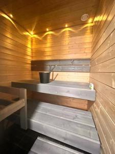 a sauna with a bench in a wooden wall at 2 Room / Central Railway / Free parking / Sauna in Oulu +5 photos