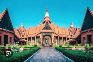 a building with a gate in the middle of a courtyard at Somato Hotel in Phnom Penh