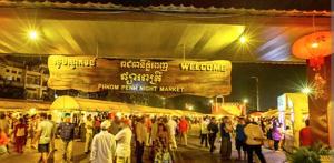 a crowd of people walking around a market at night at SOMA HOTEL in Phnom Penh