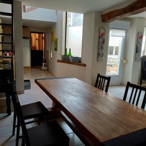 a dining room with a wooden table and chairs at Esterline in Hautvillers