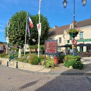 a street with flags and a sign in front of a building at Esterline in Hautvillers +11 photos