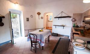 a kitchen with a table and chairs in a room at La Casa di Masaniello - Terrace & Seaview in Atrani
