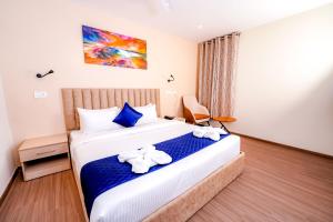 a hotel room with a bed with towels on it at Casa Hotel & Suites, Gachibowli, Hyderabad in Hyderabad