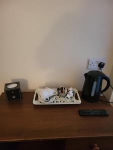 a tray on a table with a coffee maker and a coffee mug at The Jolly Sailor in Scalby