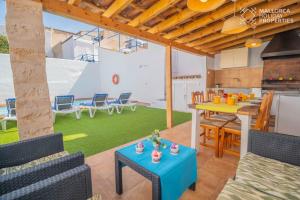 a living room with a table and chairs at Villa Fonte in Port de Pollensa