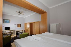 a bedroom with a bed with two towels on it at Hotel Zlatá Štika in Pardubice