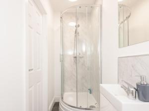 a white bathroom with a shower and a sink at Pass the Keys The Couples Nest close to Leeds city centre in Leeds