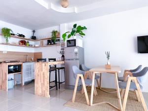 a kitchen with a table and chairs in a room at Secret Place in Panwa Beach +36 photos