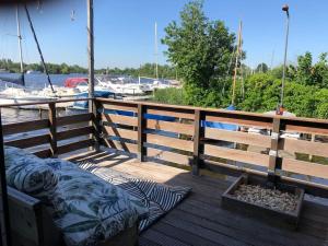 a bed on a wooden deck next to a marina at Villa Waterwolf in Aalsmeer