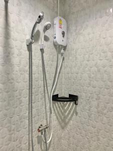a shower in a bathroom with a shower at Marni BKK Hostel in Bangkok