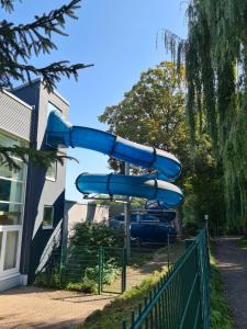 a blue water slide in a playground at FeWo Liam in Alsfeld