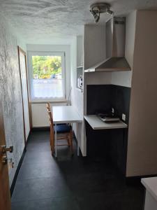 a small kitchen with a table and a window at FeWo Liam in Alsfeld