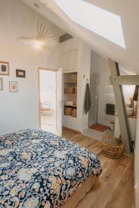 a bedroom with a bed and a ladder in it at Grange Petite Brise bord de mer in Luc-sur-Mer